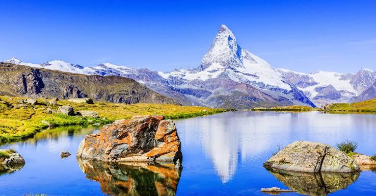 The Matterhorn rising in perfect reflection above an alpine lake