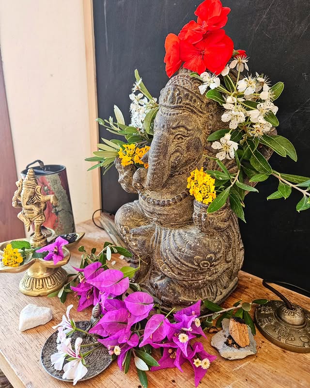Sacred ceremony — Ganesh altar, flowers, intention