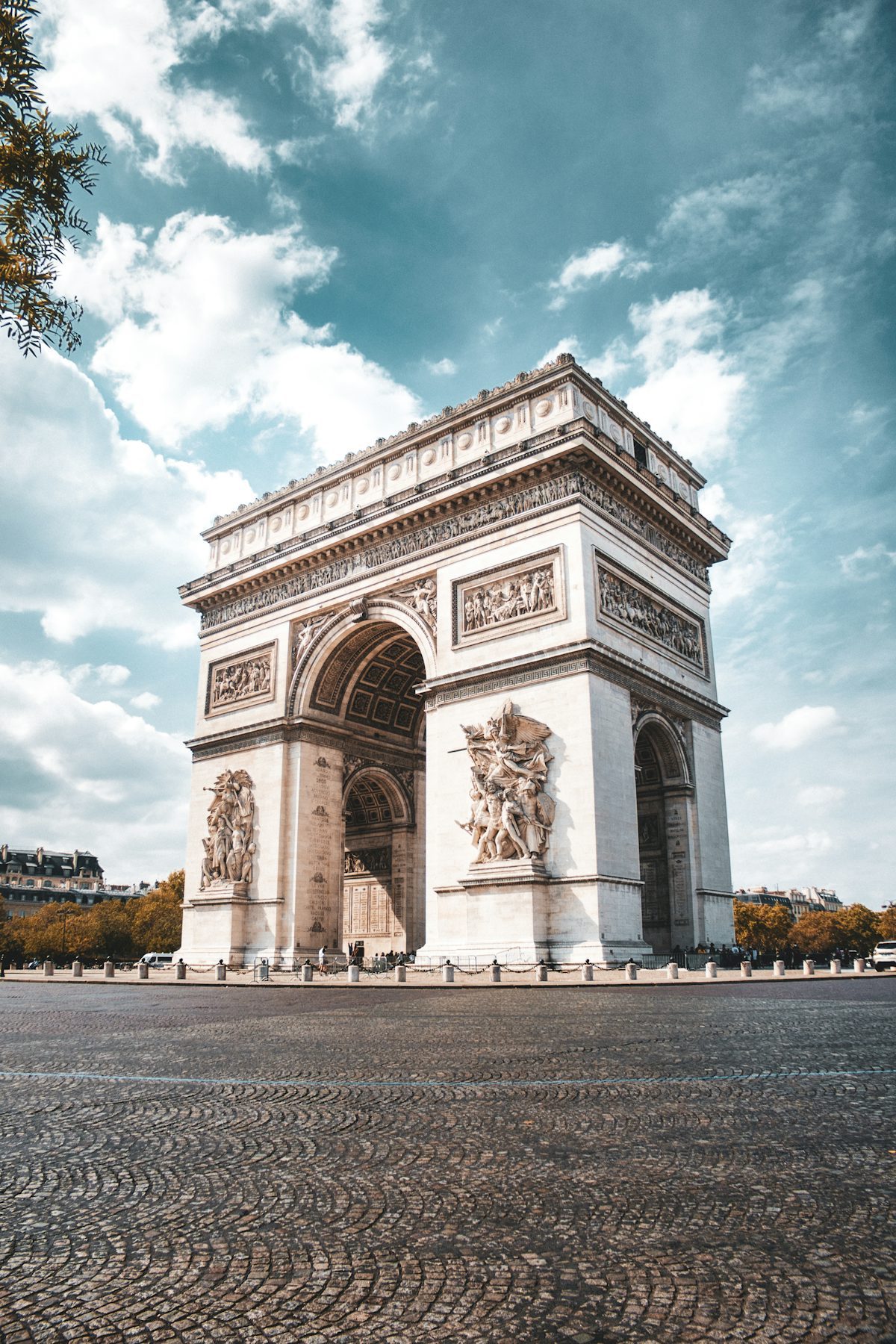 The Arc de Triomphe under a vast blue sky