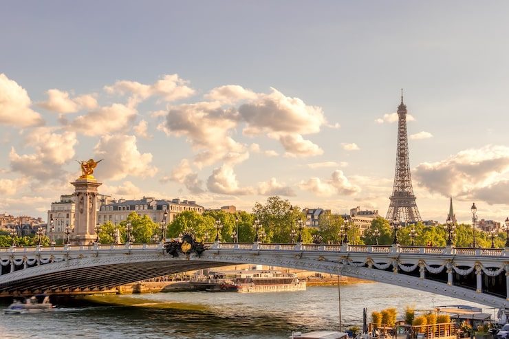 A Paris bridge over the Seine with the Eiffel Tower in the distance