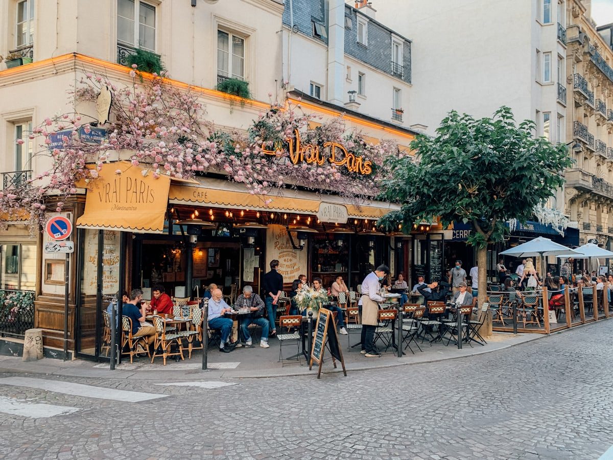 An ivy-covered café façade in daylight